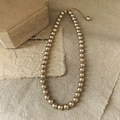 Elegant champagne gold pearl necklace with adjustable chain on linen background - 8mm / Champagne