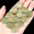 Green aventurine stones with gold zodiac symbols set of twelve held in hand - Green Aventurine (12 Pcs)