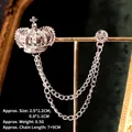 Detailed view of silver crown brooch with dual tassels and sparkling crystal on stand - Silver Crown Chain Style (TL24051)