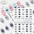 Detailed view of evil eye nail stickers with blue geometric patterns and artistic samples - Me127