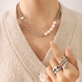 Chunky silver chain necklace with freshwater pearls and silver rings worn on model - Steel