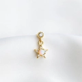 Macro shot of gold star earring featuring a pink opal center and sparkling cubic zirconia - Single Gold - Style D (Five-point Star)