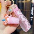 Detail of pink milk tea cup keychain with donut decoration and Pretty Good silicone wristlet - Pink (Individual Packaging)
