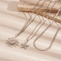 Detailed shot of silver-tone necklaces with sun face and starfish pendants on stone décor - Silver (3-Piece Set)
