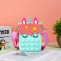 Detail of mint green unicorn pop-it purse with pink polka dot strap on a desk - Light Green