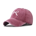 Close-up of vintage washed cotton baseball cap with white bow embroidery in burgundy - Bow Wine Red