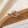 Detailed view of a gold heart pendant with Cupid's arrow and inlaid white crystals - Cupid's Arrow with 14 White Zircons