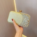 Detail of luxury gold rhinestone clutch bag with sparkling sequins and gem closure - Gold
