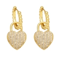Detailed macro shot of gold heart-shaped lock earrings with pavé set cubic zirconia - White