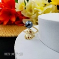 Detail of golden monstera leaf ring with black pearl on white display stand - Black Pearl Style (HEX1037-12)