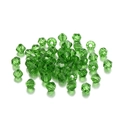 Macro detail of emerald green faceted bicone glass crystal beads for DIY jewelry - 3mm / Grass Green