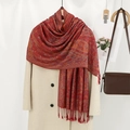 Detailed view of red paisley scarf with tassels draped over a beige winter coat - VE040 Red