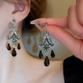 Detail of vintage silver earrings with green crystals and black teardrop beads on a model - E2036 Black / 925 Silver Earring Post