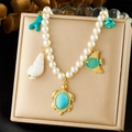 Gold-plated pearl necklace featuring turquoise turtle, fish and shell charms for ocean style - Ocean Elements Pearl Style (N3596)