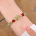 Handcrafted pearl and sea blue beaded bracelet with jade rings worn on a female wrist - S074 - Interlocking Bracelet With Red Beads #sz576