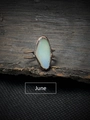 Macro view of June birthstone moonstone set on a vintage bronze adjustable split ring - June - Moonstone