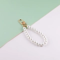 White glass pearl handbag strap with gold metal buckle on a minimalist background - White Pearl + KC Buckle