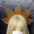 Close-up of golden star elements on an orange halo crown headpiece with spiked texture - Orange Gold Starburst (Style 5)
