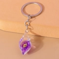 Dettaglio portachiavi a conchiglia in resina viola con conchiglia decorativa - Viola