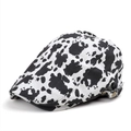 Vintage cow print newsboy cap with adjustable metal buckle and black and white pattern - Cow