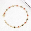 Gold stainless steel bracelet featuring red and black enamel heart charms and lobster clasp - Black and Red