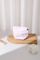 Detailed shot of pink heart embroidered makeup bag with a gold flower zipper pull - Small / Pink