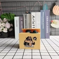 Detail of creative yellow gorilla money box stealing coins on a decorative checkered table - Gorilla / Ginger Yellow