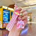 Pink unicorn keychain with liquid glitter star pendant and rubber wristband detail - Luminous Donut Five-Pointed Star