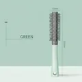 Mint green 45mm rolling hair comb with ergonomic matte handle and grey bristles - Round Comb / Mint Green