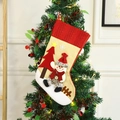 Christmas stocking with snowman and rustic burlap design hanging on a decorated Xmas tree - Snowman