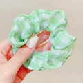 Detail of soft green and white checkered scrunchie showing fabric texture and pleats - Green Checkered