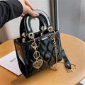 Elegant black patent leather quilted handbag with gold hardware and heart pendant - Large / Black