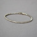 Macro shot of silver-plated tennis bracelet with sparkling cubic zirconia on grey background - Silver 16cm
