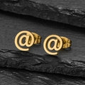 Detailed macro view of gold-plated stainless steel stud earrings in at symbol shape - @ Symbol Gold