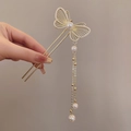 Épingle à cheveux papillon dorée avec perles et long pompon sur la main - Épingle à Cheveux Papillon Creux Doré avec Perle Artificielle et Frange (43#)