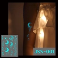 Luminous moon and star tattoo stickers with cyan glow effect on model arm - JSN-001 (Luminous Moon Stars)