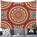 Detailed Bohemian mandala tapestry in orange and teal hues above a cozy living room sofa - 100x70cm / Style 21 (Orange-Red and Turmeric Yellow Mandala)