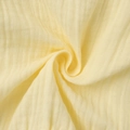 Macro shot of yellow tiered muslin skirt fabric showing soft texture and pleated details - S / Yellow