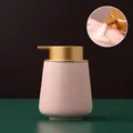 Pink ceramic soap dispenser with sesame glaze finish and golden pump in Nordic style - Rounded / Pink with Gold Pump