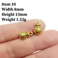 Macro shot of 8x13mm antique gold money bag charms with dollar sign engraving - 10# Money Bag $