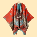 Detail of Christmas poncho with reindeer and snowflake patterns and tassel edges - Christmas Deer Orange