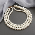 Three-layer faux pearl necklace with elegant triple-strand design and gold lobster clasp - Classic Three-Layer Layered Pearl Necklace