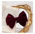 Elegant wine red velvet large bow hair clip placed on a vintage mirror with book - Retro Velvet Style / Red Velvet Bow Clip