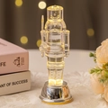 Transparent acrylic nutcracker king figurine with warm LED lights and silver base - Nutcracker Style C