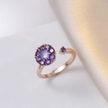 Elegant rose gold rotating flower ring with purple crystals on a soft silk background - Purple Flower Open Ring