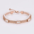 Detalle de pulsera multicapa en oro rosa con tres adornos de circonitas rectangulares - Oro rosa