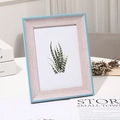 Detail of light wood grain photo frame with blue trim holding a succulent art print - 5 inch (9*13cm) Tabletop / Blue Pink