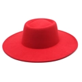 Detailed texture of flat top red wool felt hat with a wide brim for autumn fashion style - Red