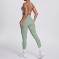 Close-up of sage green yoga set showing cross-back sports bra and high-waisted leggings - S / Basil Green