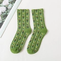 Green knitted socks featuring delicate floral patterns and ruffled scalloped cuffs - One Size / Green